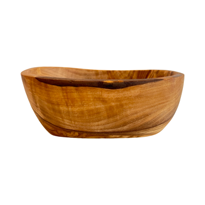 side view of a olive wood tapas bowl with an uneven edge.