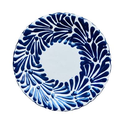 Top view of a blue and white Puebla talavera round plate