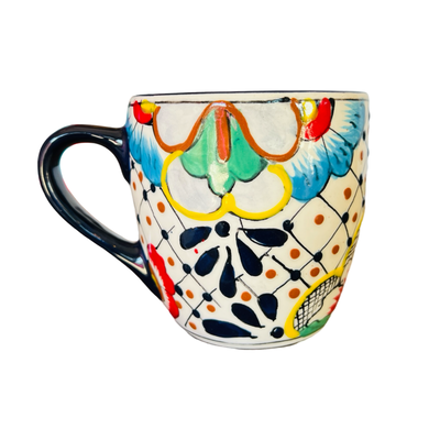 one ceramic mug that features the traditional Mexican talavera design with blues, yellows, reds and black.