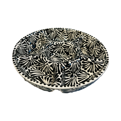 side view of a 6-compartment round appetizer tray with a black and white Puebla design