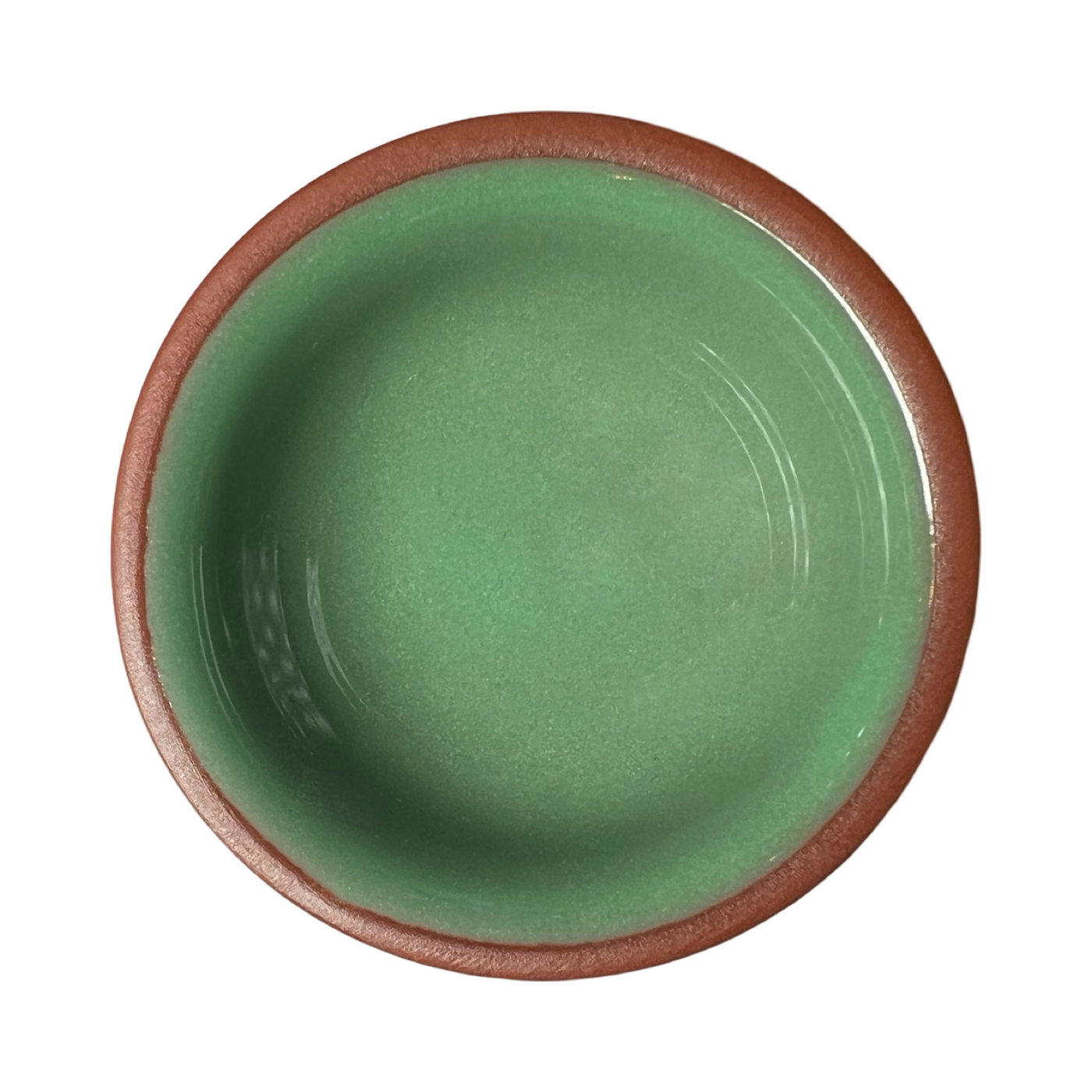 terracotta pinch bowls with an unglazed exterior and glazed interiors in sage green