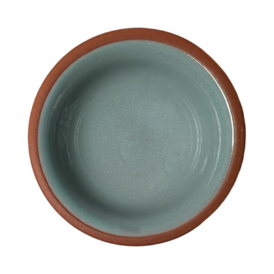 terracotta pinch bowls with an unglazed exterior and glazed interiors in light blue