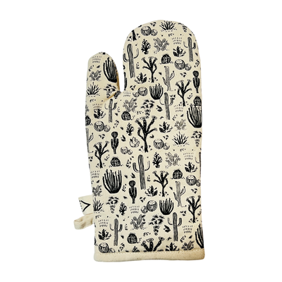 single cream colored oven mitt with a black desert cactus design