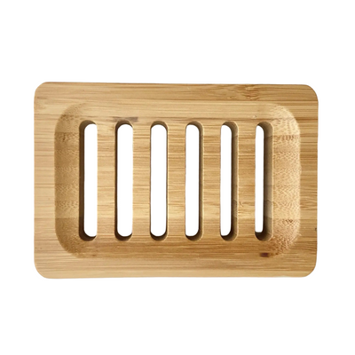 Top-down view of a large rectangular wooden soap dish with six vertical drainage slots and rounded corners, in light natural wood on a white background.