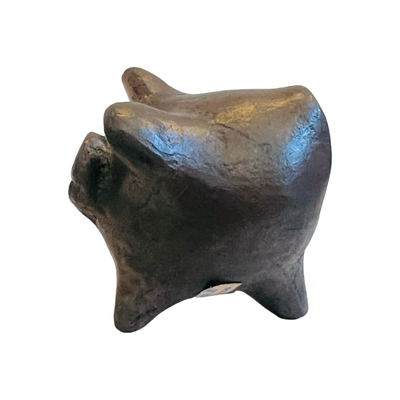 side view of dark brown clay pig