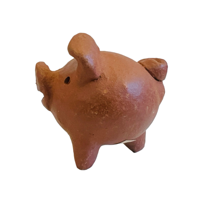 side view of red clay pig