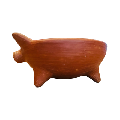 Side view of a red clay pig bowl