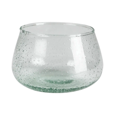 Round short clear glass with a green hue and features air bubbles in the glass