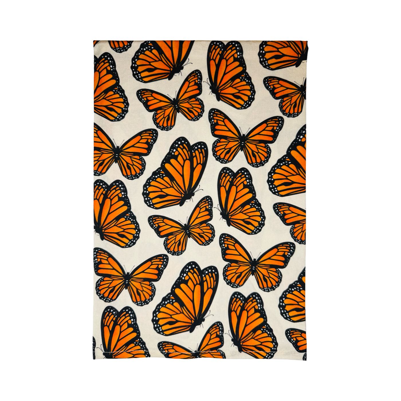 Kitchen towel with a repeating pattern of vibrant orange and black monarch butterflies on a cream background.