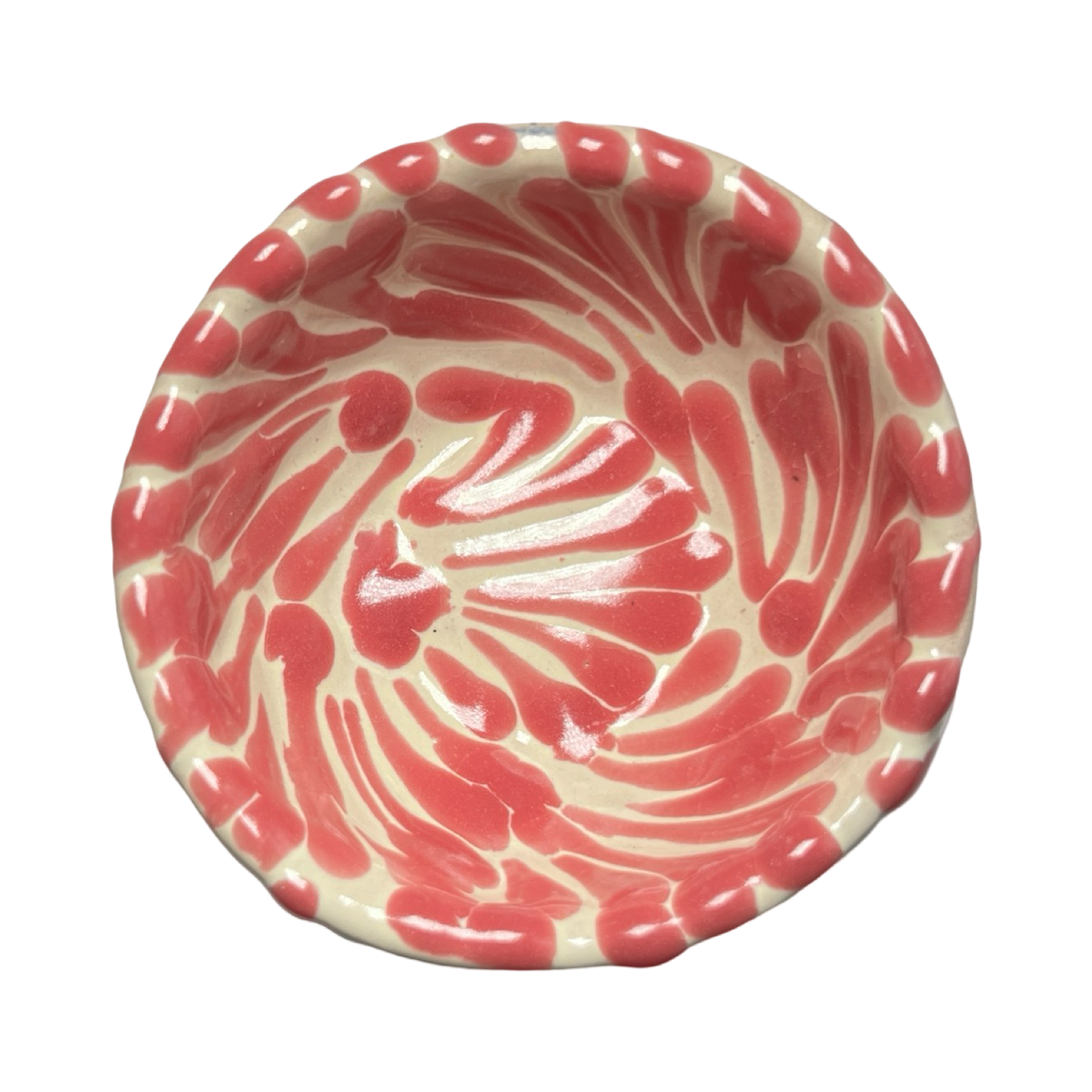 top view of a small round bowl with a pink and white Puebla design