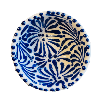 top view of a small ceramic bowl with a blue and white Puebla design