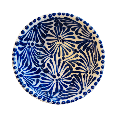 top view of a small ceramic bowl with a blue and white Puebla design