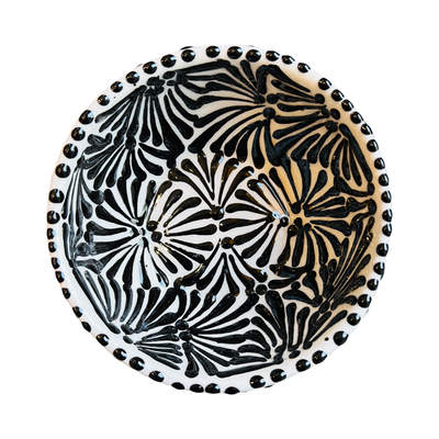 top view of a small ceramic bowl with a black and white Puebla design