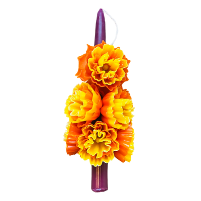 purple stick candle decorated with multiple wax marigolds 