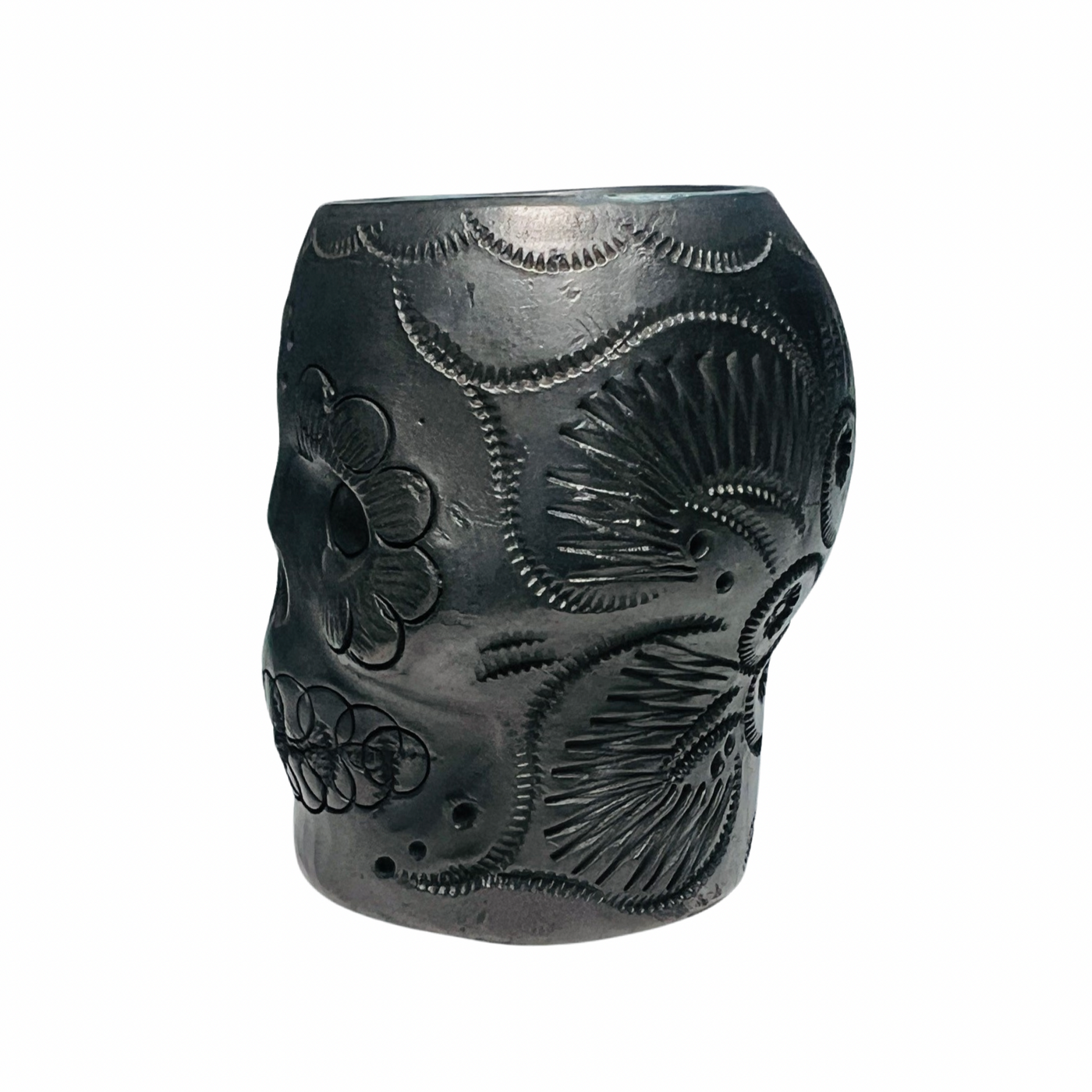 side  view of a black clay shot glass with a sugar and floral design.