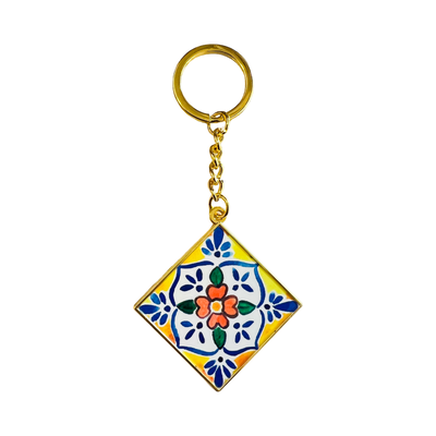 gold keychain with an enamel Mexican tile square featuring a white, yellow and blue Mexican tile design.