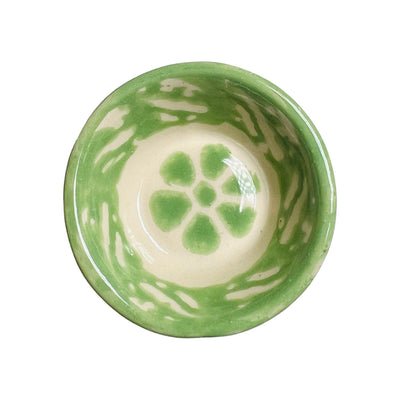 green ceramic bowl with a flower design