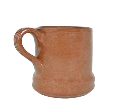 side view of red clay mug, handle is shown