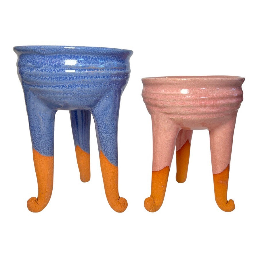 set of barro rojo copaleros with one having a blue-purple glaze and the other a blush colored glaze