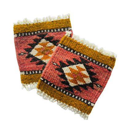 set of goldenrod, blush and black wool coasters with an Aztec design