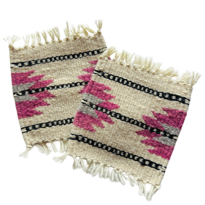 sert of beige, blush and black wool coasters with an Aztec design.