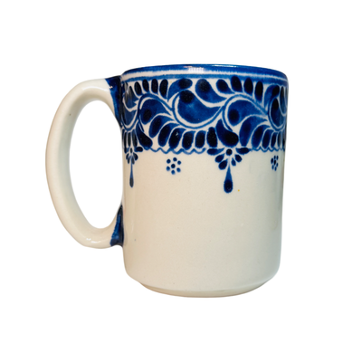 ceramic white mug with a blue decorative design on the top edge