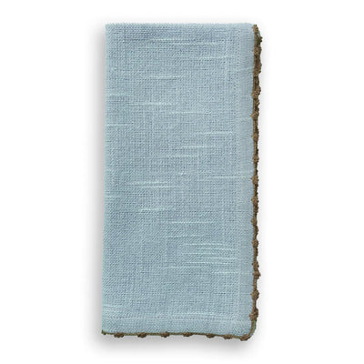 Folded light blue cotton napkin with natural brown knotted edge trim.