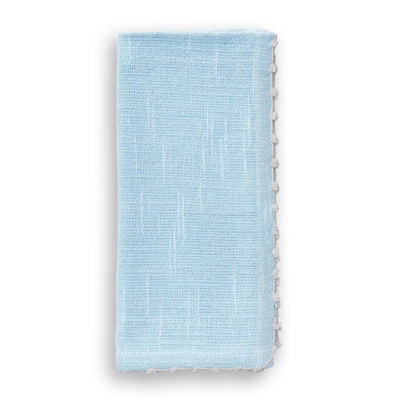 Folded light blue cotton napkin with a hand-knotted white trim along the edge.