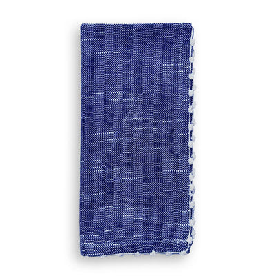 Folded navy cotton napkin with hand-knotted white trim detail along the edge.