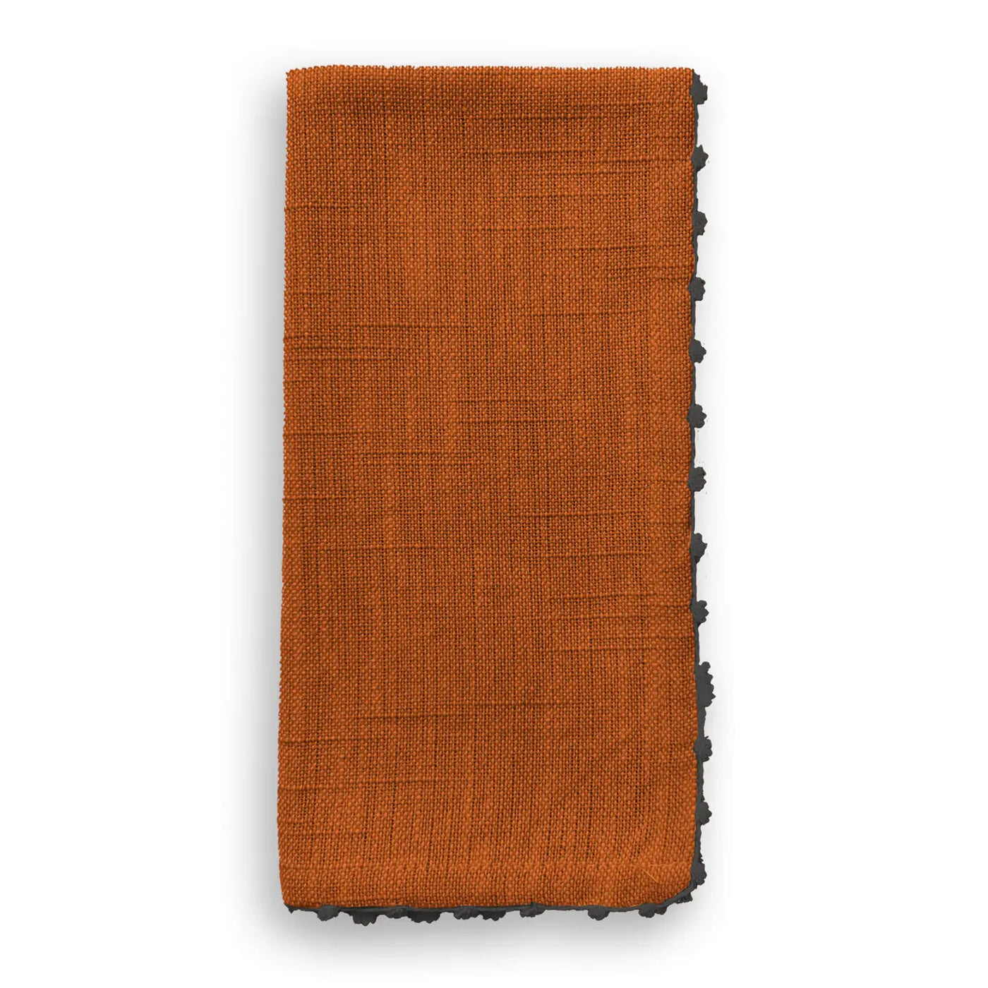 Folded cotton napkin in a warm tomato cream color with grey knotted trim detail.