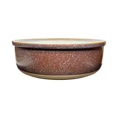Plum purple stoneware bowl with a speckled glaze and matching plate used as a lid, featuring a clean, modern design.