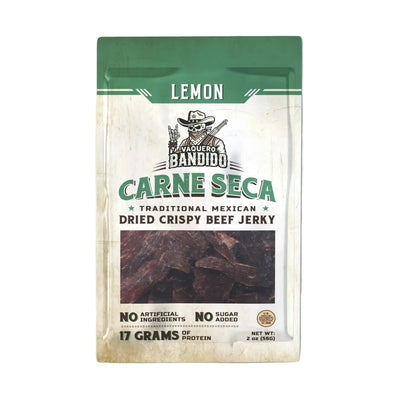 Front of Vaquero Bandido “Lemon Carne Seca” pouch with green header and window showing dried beef; label reads “Traditional Mexican Dried Crispy Beef Jerky,” “No Artificial Ingredients,” “No Sugar Added,” “17 Grams of Protein,” net wt. 2 oz.
