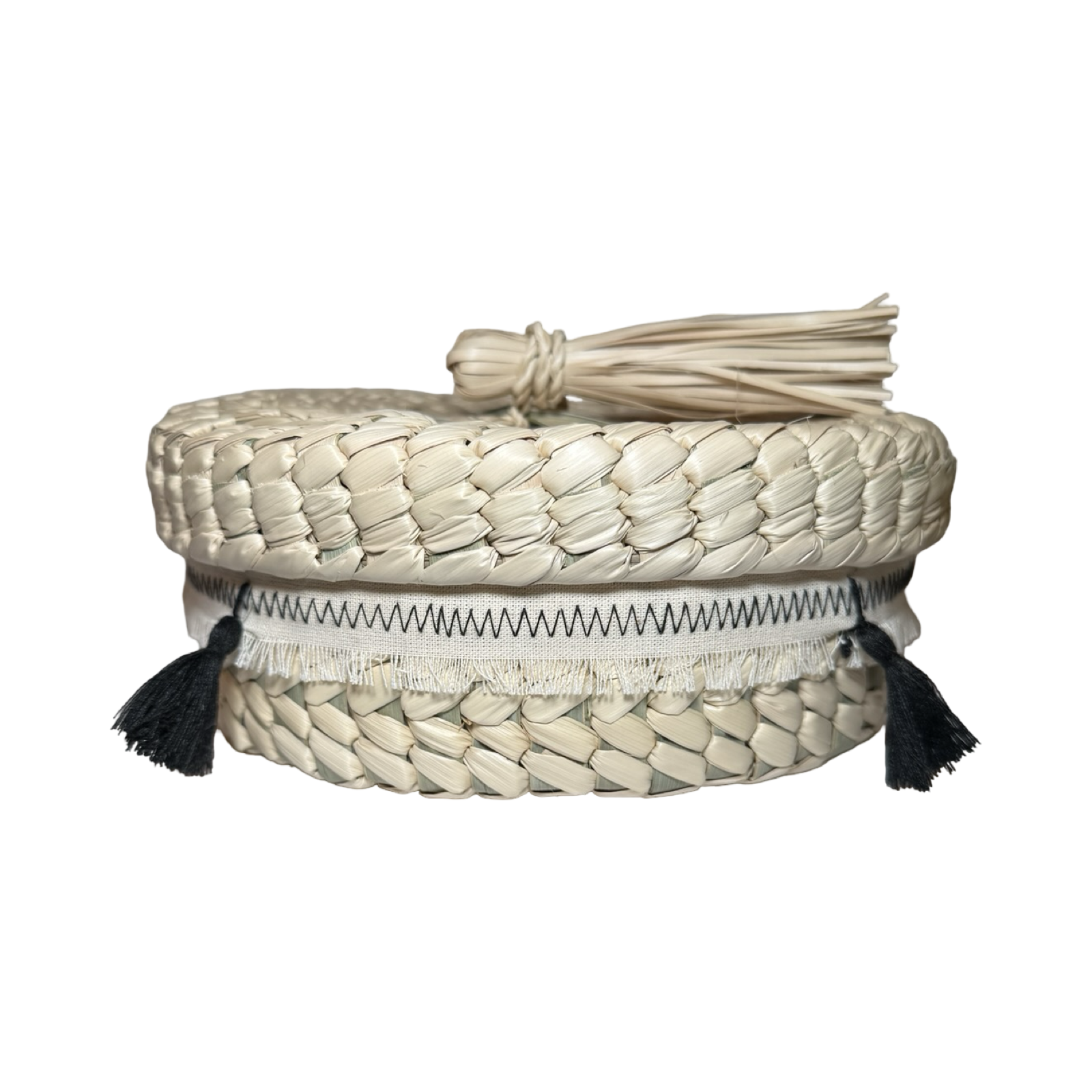Woven basket with a lid and tassels on a white background