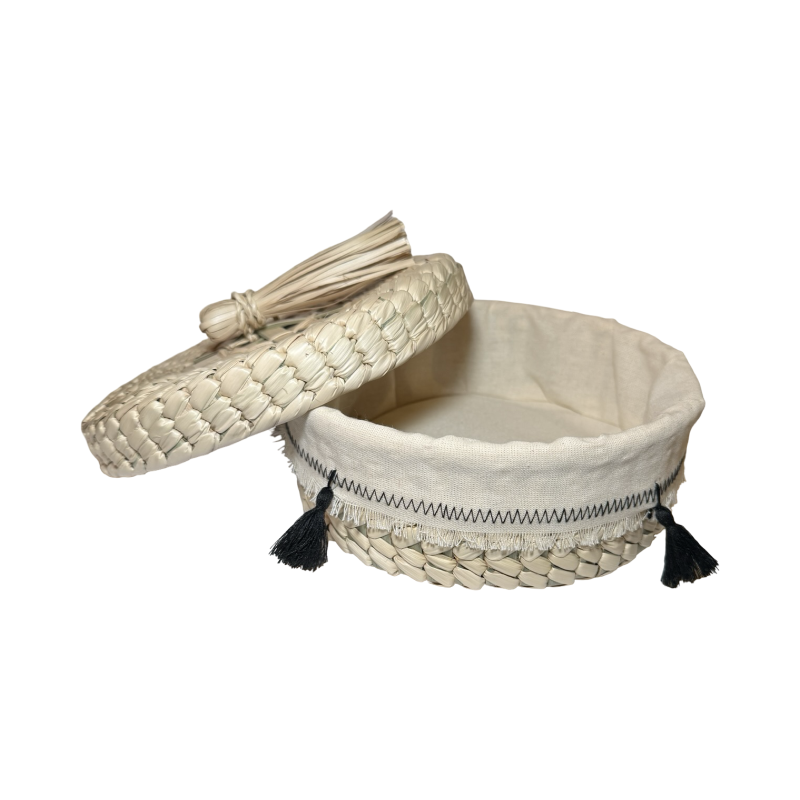 White woven basket with a lid and tassels on a white background