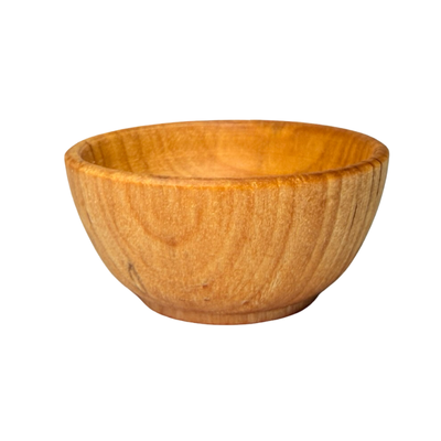 Small wooden pinch bowl with a smooth, rounded shape and light natural grain.