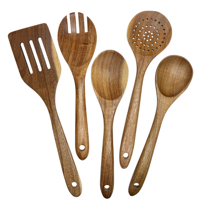 Set of wooden kitchen utensils including a spatula, spoon, and ladle on a white background