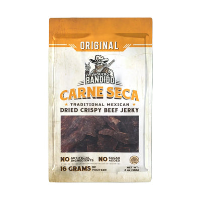 Front of Vaquero Bandido “Original Carne Seca” pouch with window showing dried beef; label reads “Traditional Mexican Dried Crispy Beef Jerky,” “No Artificial Ingredients,” “No Sugar Added,” “16 Grams of Protein,” net wt. 2 oz.