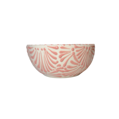 side view of a bowl with the Puebla signature pink and white glazed talavera design.