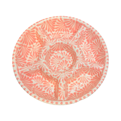 top view of a 6-compartment round appetizer tray with a coral and white Puebla design.