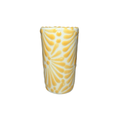 shot glass with the Puebla signature yellow and white glazed talavera design.