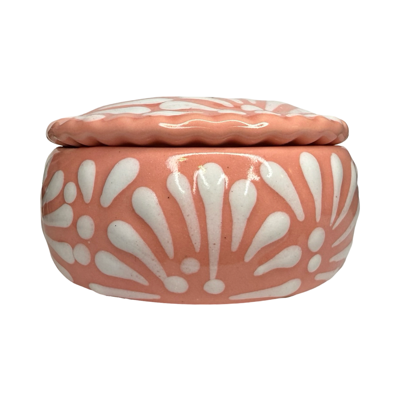 Ceramic jar with white floral patterns on a peach-colored background