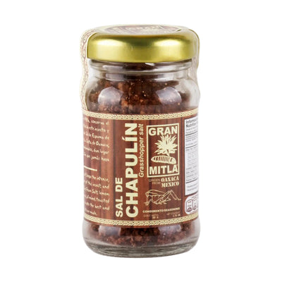 50g Clear jar with a gold lid, brown branded paper and filled with grounded up grasshoppers and salt.