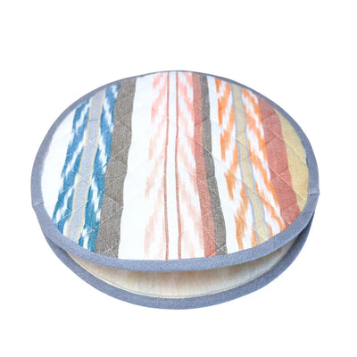 round tortilla warmer with a light sand, blue and orange striped design with a light denim blue trim.