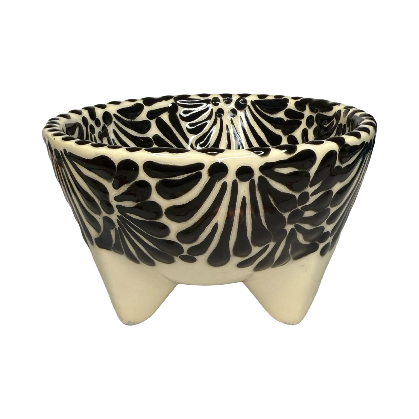 Handcrafted ceramic molcajete-style bowl with a black floral design on a cream background and three short legs.