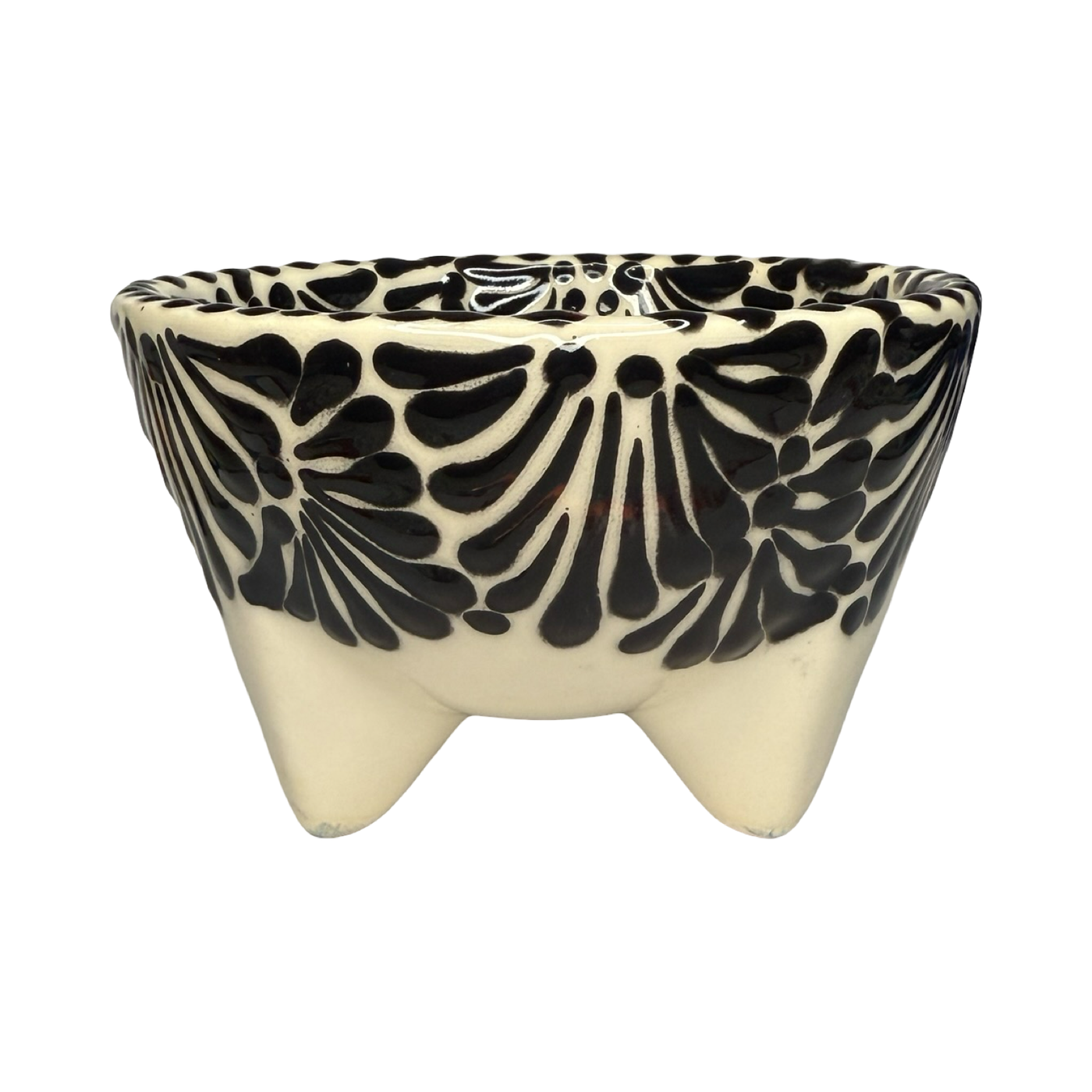 Handcrafted ceramic molcajete-style bowl with a black floral design on a cream background and three short legs.