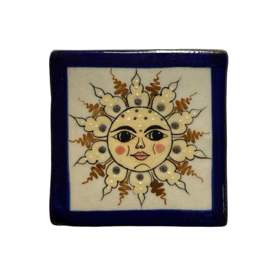square ceramic coaster with a blue border with an image of a yellow and tan sun with a face in the center.