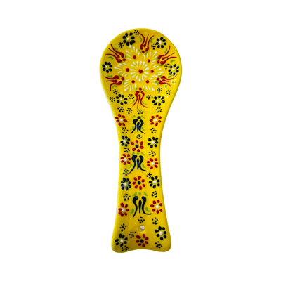 yellow spoon rest with a multi-color design