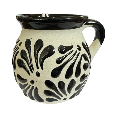 Ceramic mug with black floral patterns on a white background