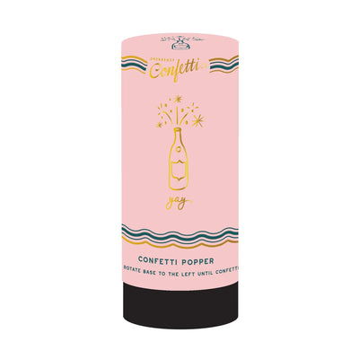 Cylindrical confetti popper labeled “Yay” with a gold champagne bottle illustration and decorative wavy lines.