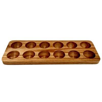 Rectangular acacia wood egg holder with 12 carved slots, designed for storing or displaying eggs, featuring a smooth finish and natural wood grain pattern.